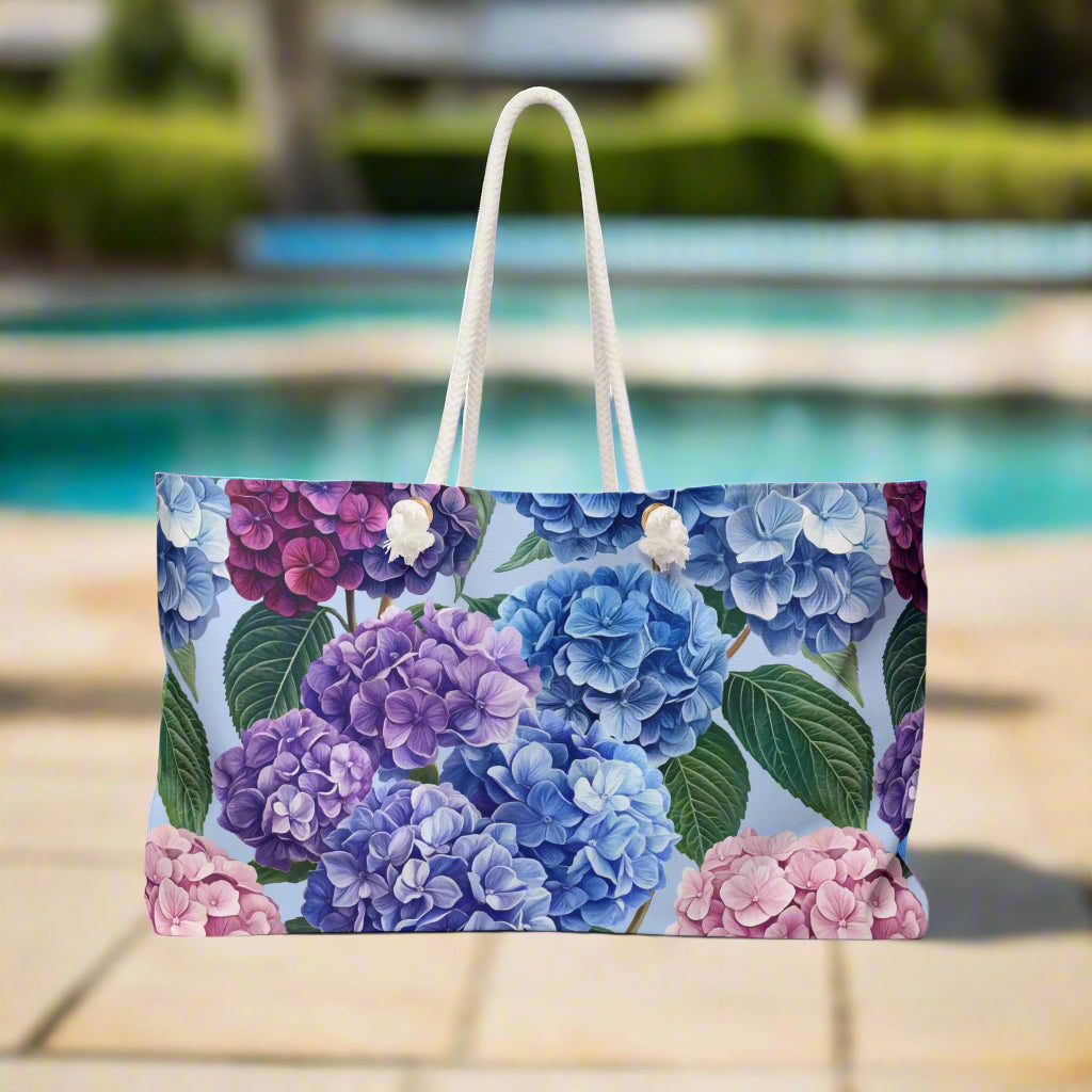 Floral-patterned (hydrangea) bag with a white handle on a white background
