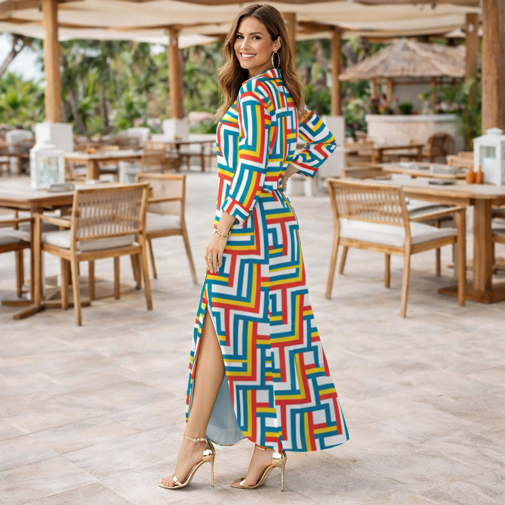 Woman in a colorful geometric dress standing in an outdoor setting with tables and chairs.