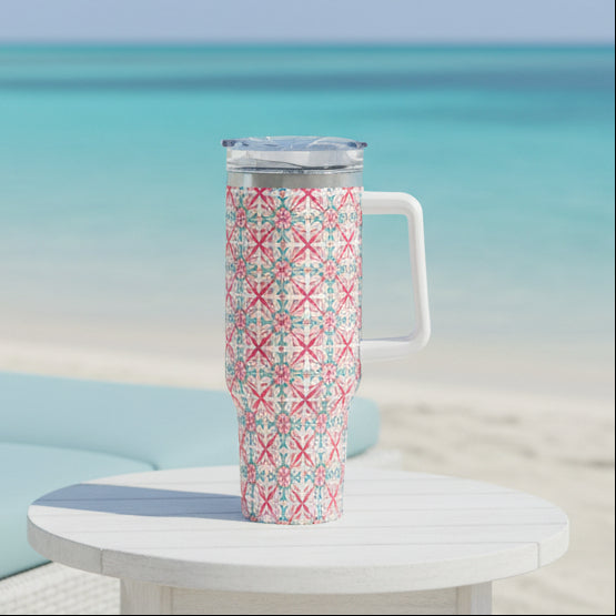 A 40oz stainless steel tumbler with a geometric Portuguese-inspired pattern in pink, teal, and green, featuring a handle and a straw.