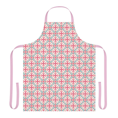 A person wearing a floral patterned apron in pink, green, and white colors standing in a kitchen setting.