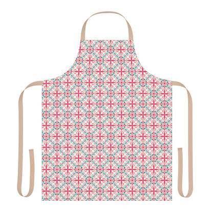 A person wearing a floral patterned apron in pink, green, and white colors standing in a kitchen setting.