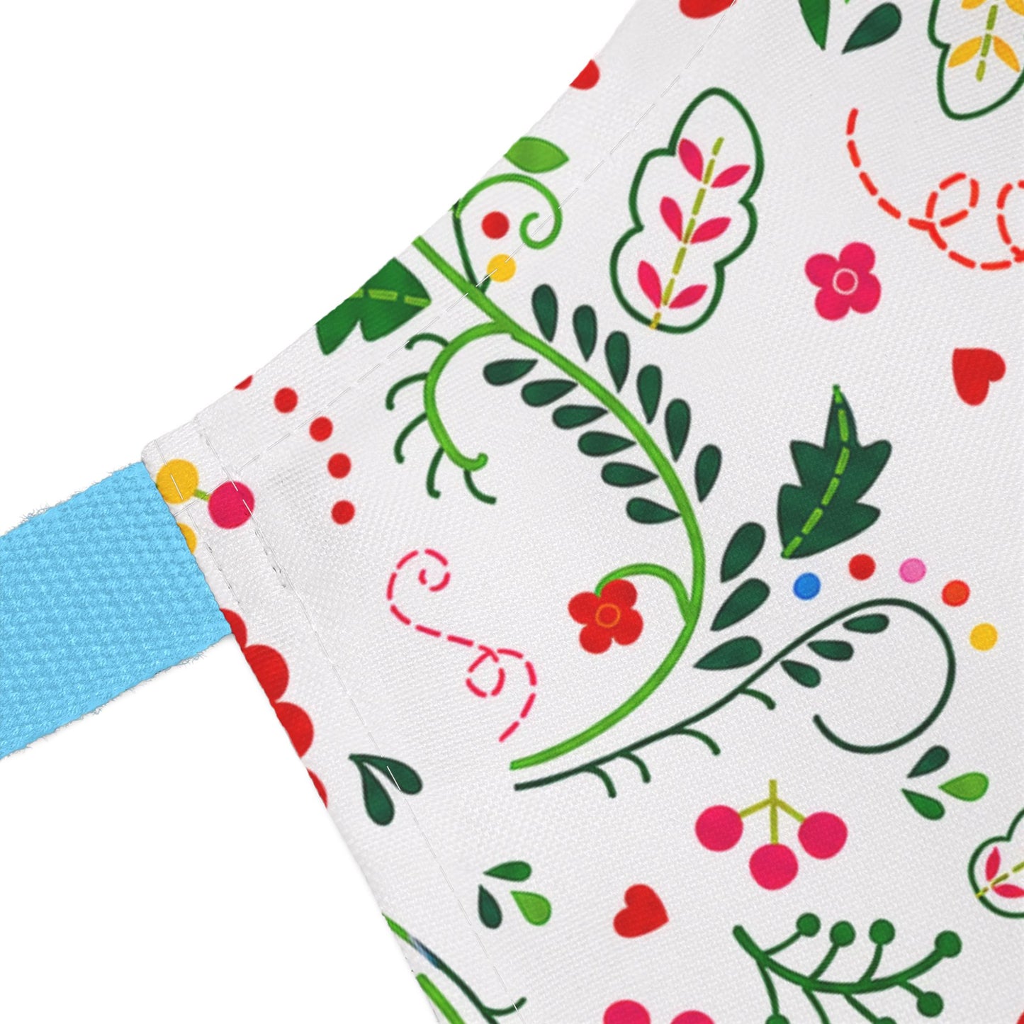 Colorful fabric with floral and leaf patterns on a white background