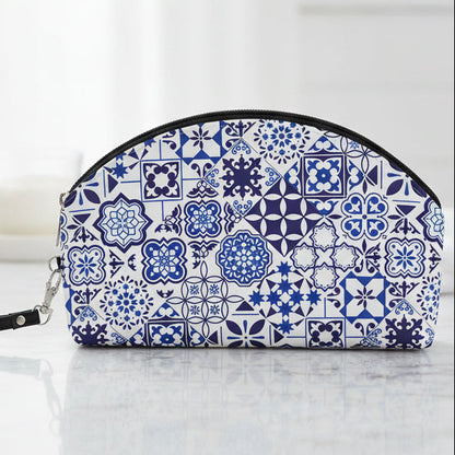 A blue and white patterned zippered pouch with a wrist strap, featuring a traditional Portuguese azulejo tile design, shown on a plain white background.