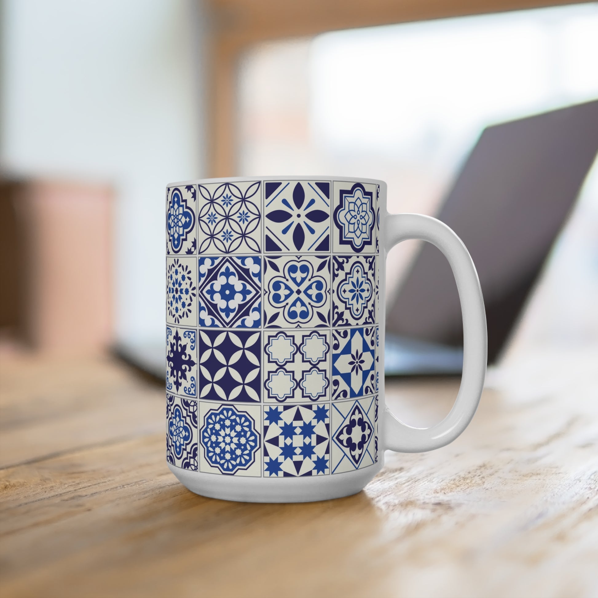 White mug with blue azulejo pattern on a wooden surface