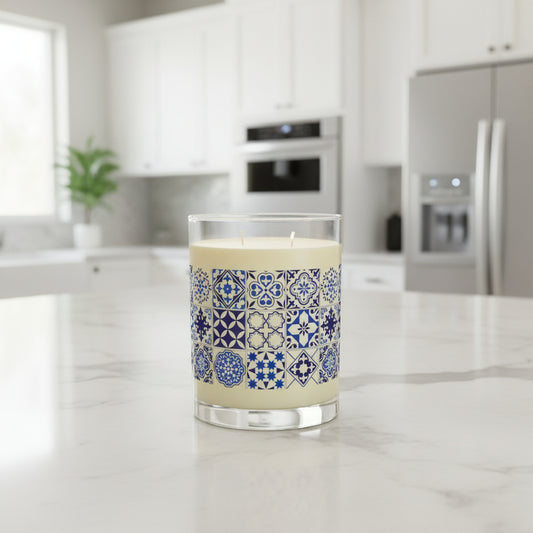 Candle with blue and white tile patterned label on a white background