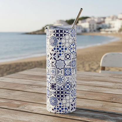 Tumbler with blue geometric pattern and metal straw on a white background