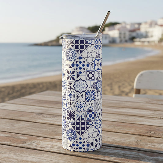 Tumbler with blue geometric pattern and metal straw on a white background