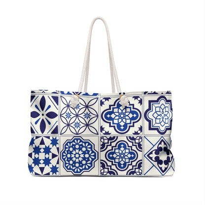 A large weekender tote bag with a blue and white Portuguese tile pattern and thick rope handles.