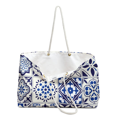 A large weekender tote bag with a blue and white Portuguese tile pattern and thick rope handles.