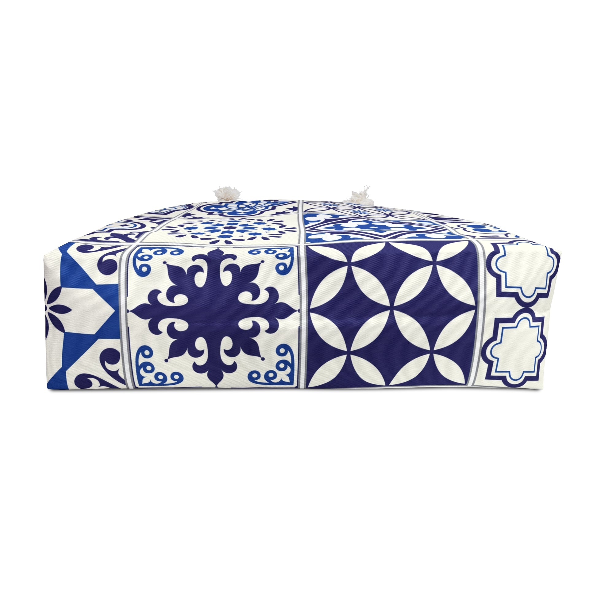 A large weekender tote bag with a blue and white Portuguese tile pattern and thick rope handles.