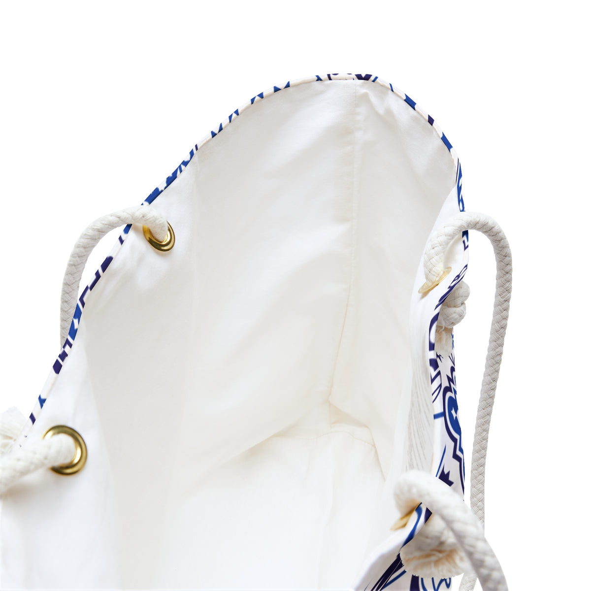 White drawstring bag with blue patterns and gold metal loops on a white background