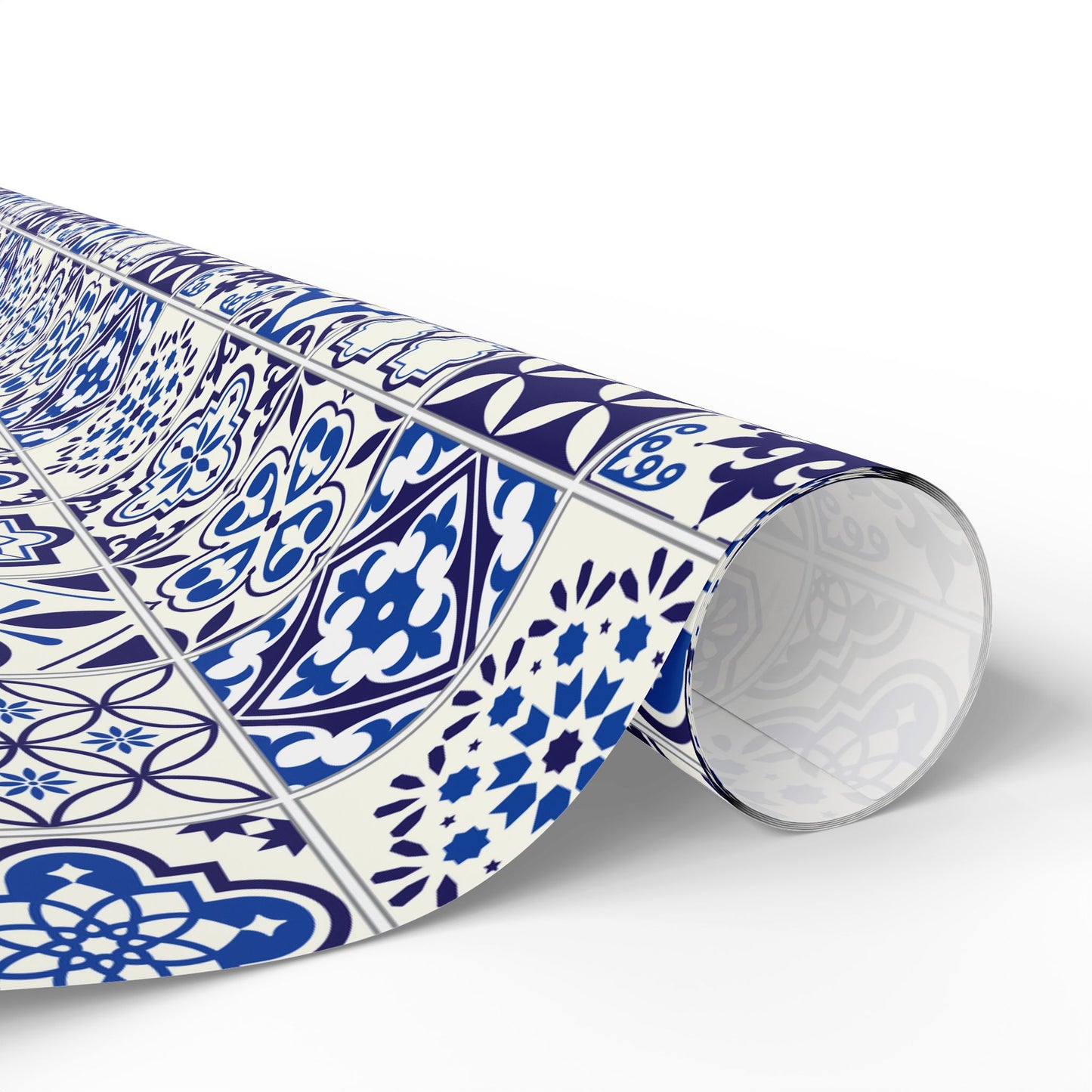 Roll of blue and white azulejo patterned paper on a white background