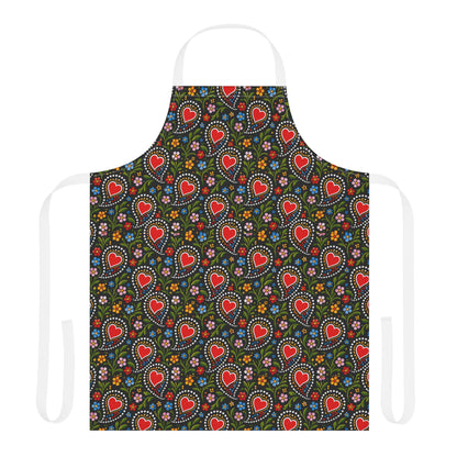 A white apron with a dark green front panel featuring a repeating pattern of red hearts, white dotted circles, and small colorful flowers, shown on a plain white background.