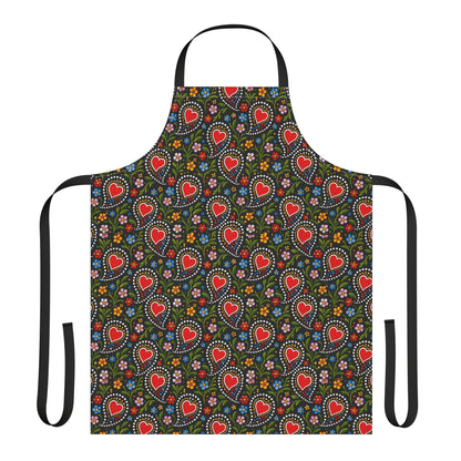 A black apron with a colorful repeating pattern of red hearts, white dotted circles, and small multicolored flowers, shown on a plain white background.