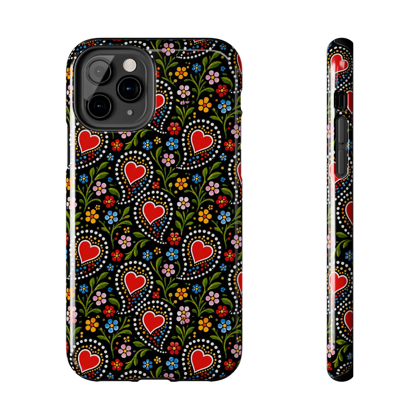 A phone case with a colorful folk-art style pattern featuring red hearts, flowers, and dots on a black background, shown from the back and side on a white background.