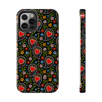 A phone case shown from the back and side on a plain white background. The case has a black base with a colorful folk-art style pattern featuring red hearts, green vines, and small multicolored flowers.