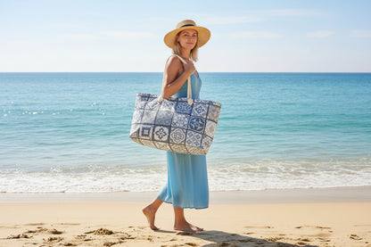 A light grey weekender tote bag with a geometric Portuguese tile pattern and thick rope handles.