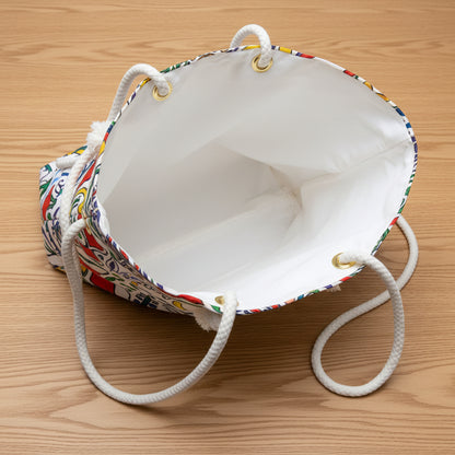 White drawstring bag with colorful drawstrings on a white background