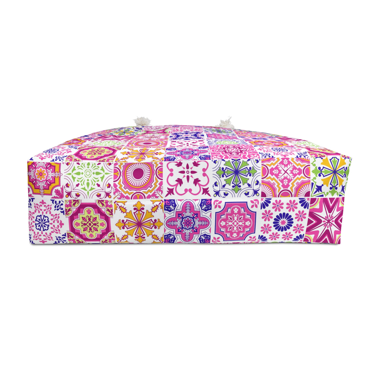 the bottom of a bag with a vibrant multicolor patchwork tile pattern, set against a plain white background.