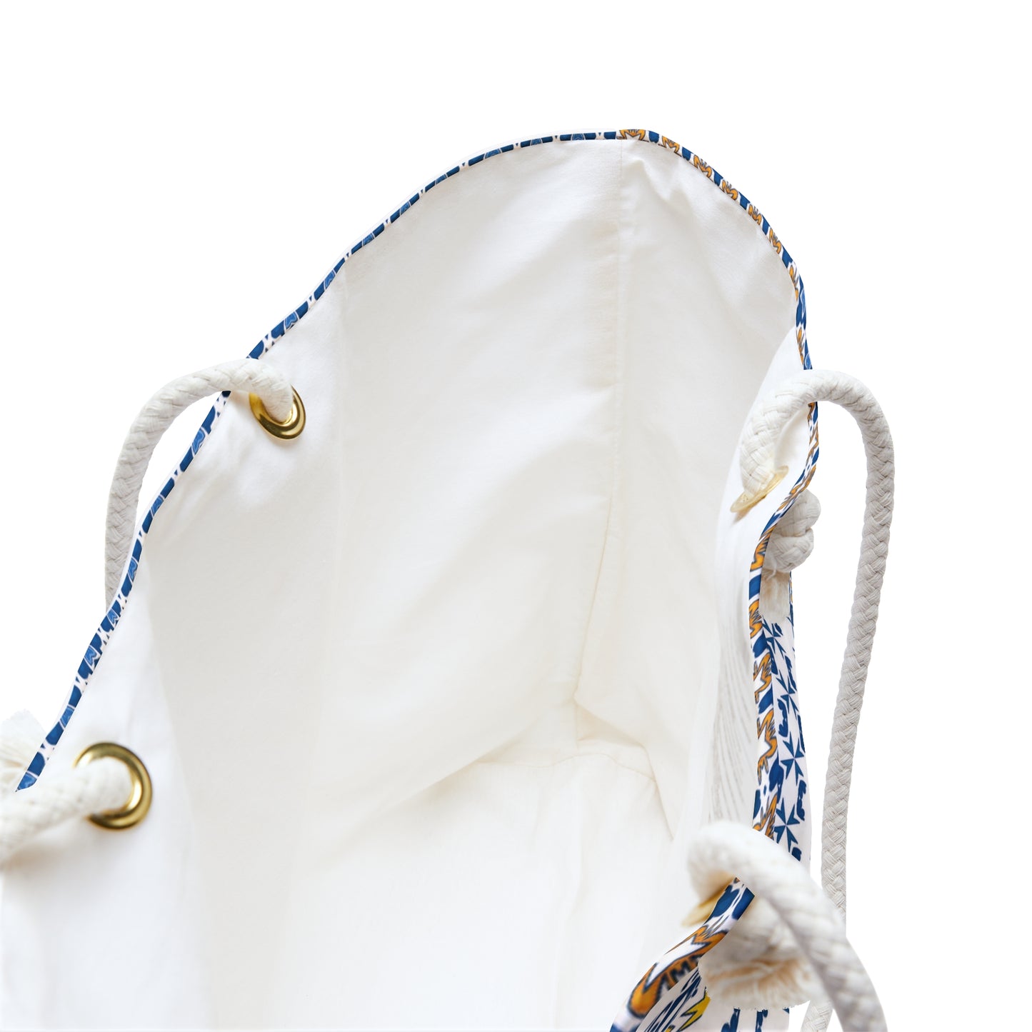 Close-up of a white drawstring bag with patterned drawstrings on a white background