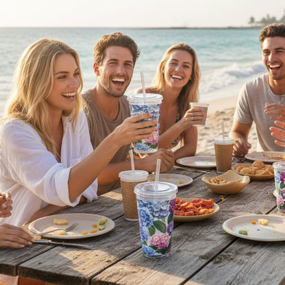 Floral-patterned tumbler with a straw on a white background