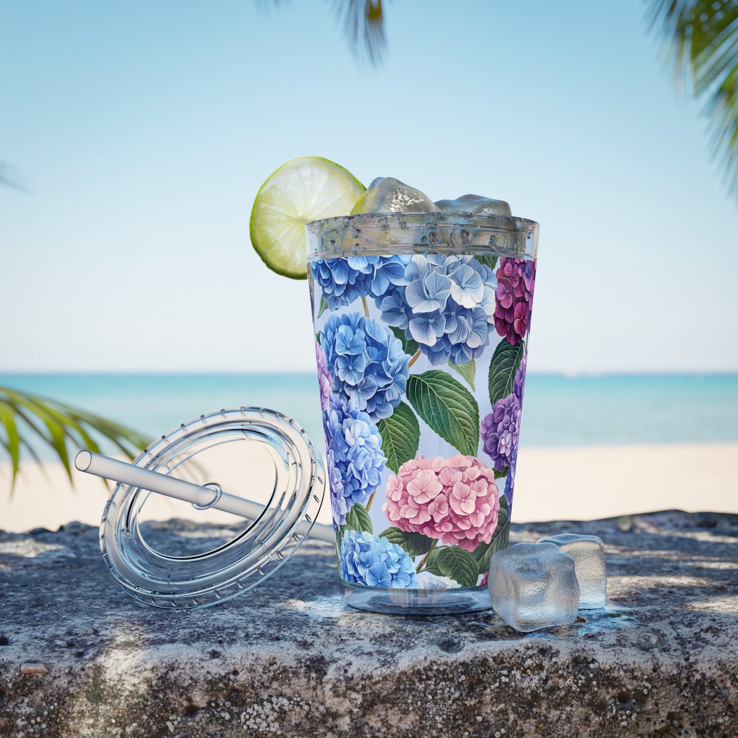 Tumbler with floral design on a beach setting