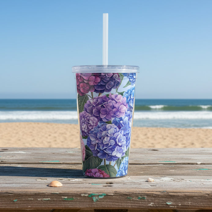 Tumbler with floral design featuring purple and blue hydrangeas on a white background