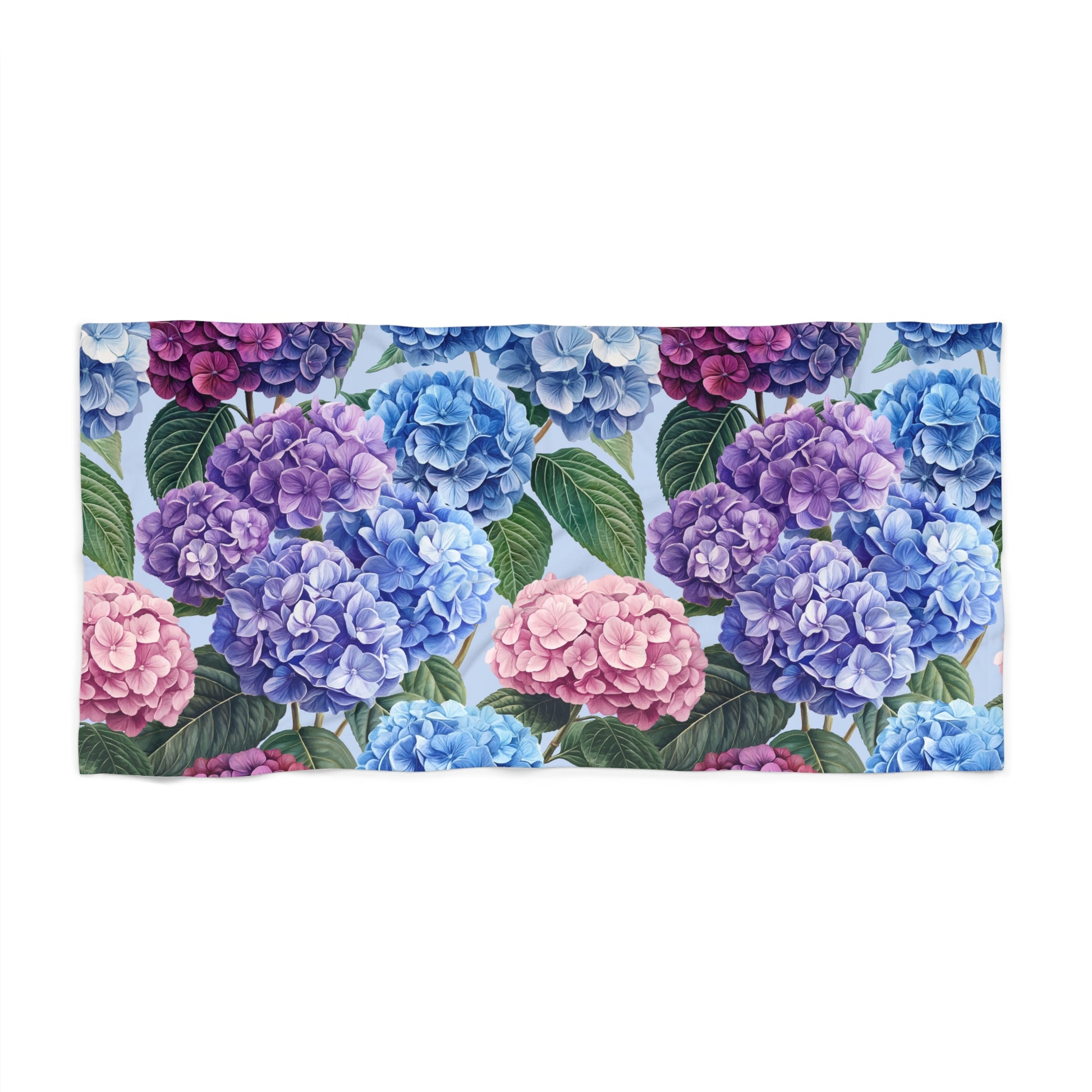 Floral patterned towel with hydrangeas in blue, purple, and pink on a white background