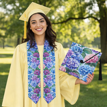 Graduate in yellow cap and gown with floral stole and folder outdoors