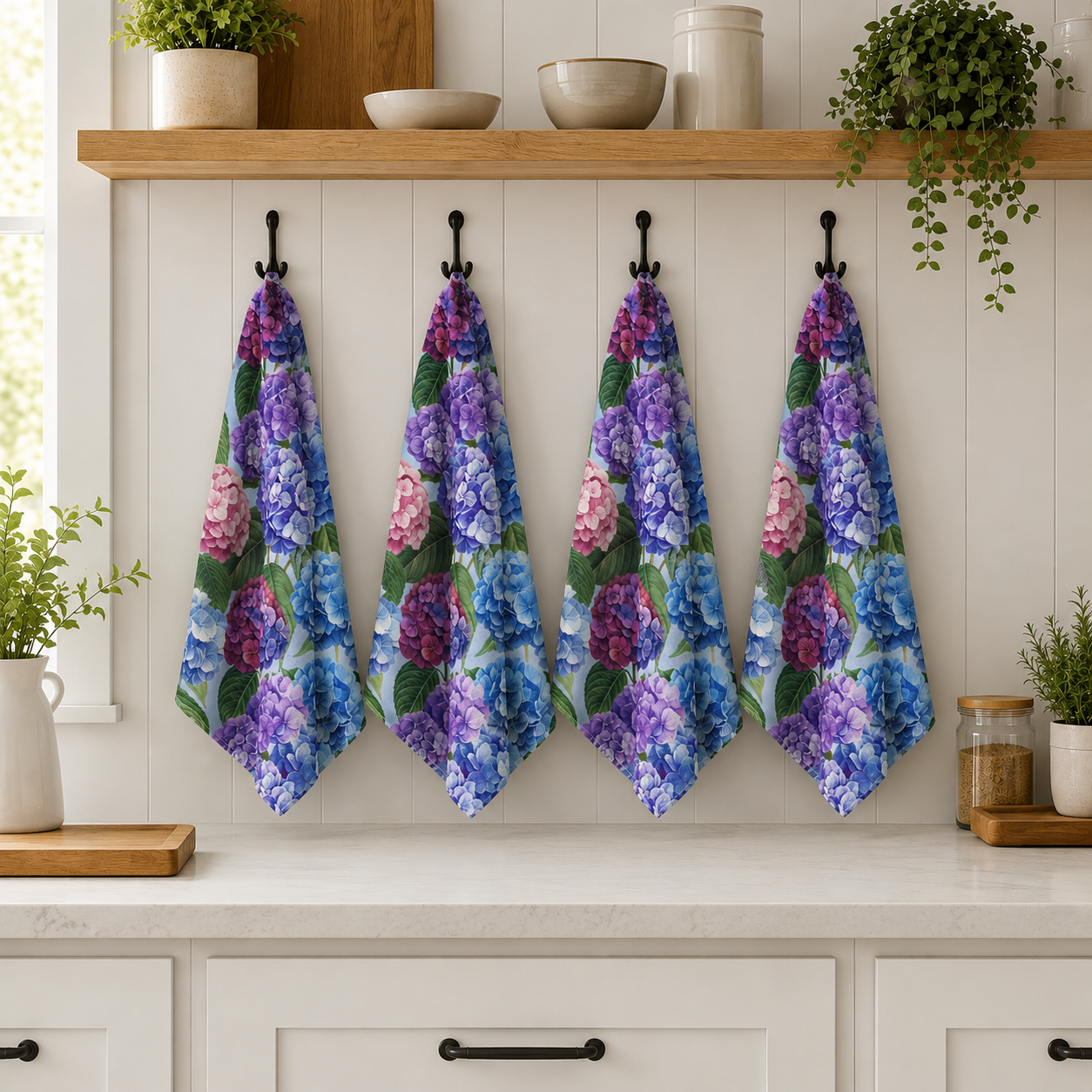 Four floral towels hanging on hooks in a kitchen with plants and shelves.