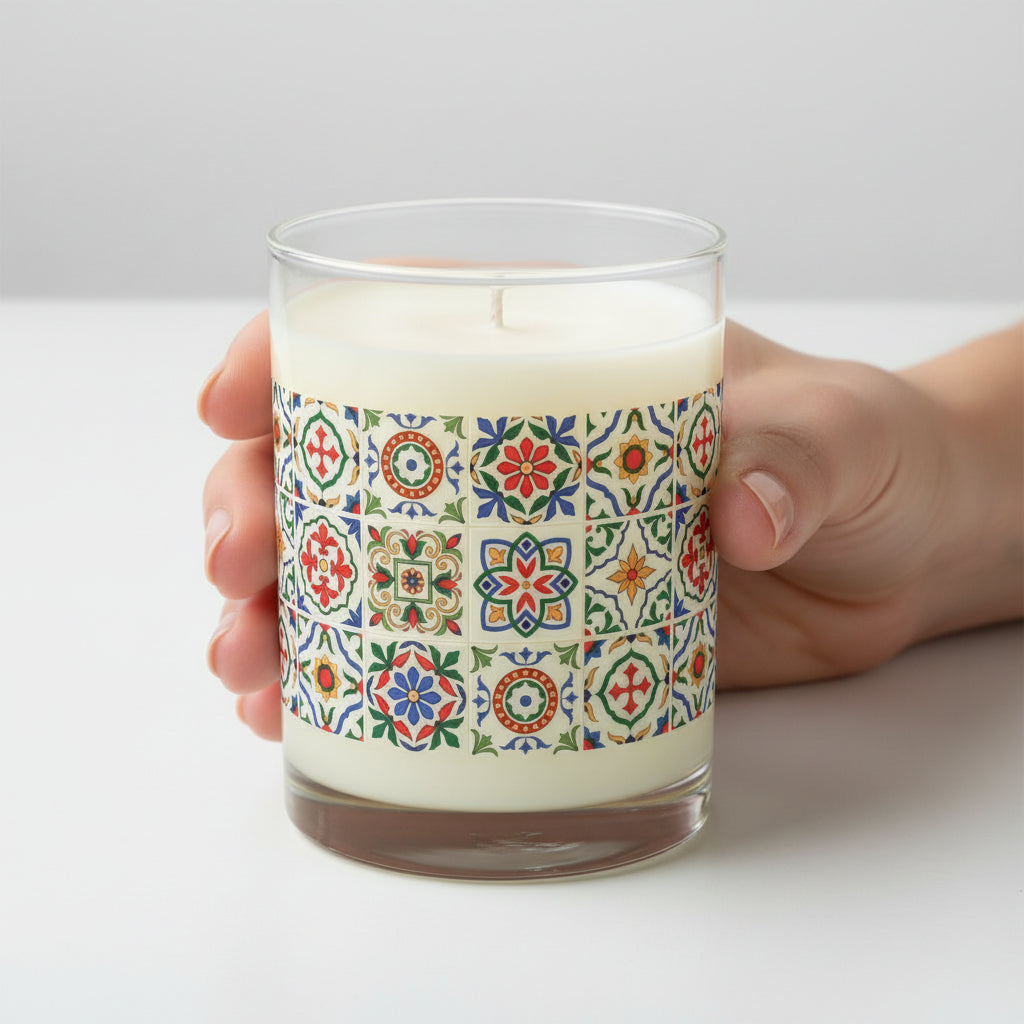 Candle with colorful portuguese tile pattern on being held by woman's hand
