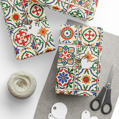 Decorative packages with colorful portuguese tile patterns, a ball of twine, and scissors on a white background