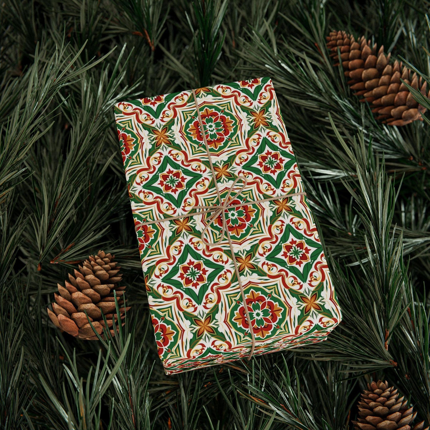 Gift box with a colorful portuguese christmas tile pattern on a bed of pine needles and pine cones