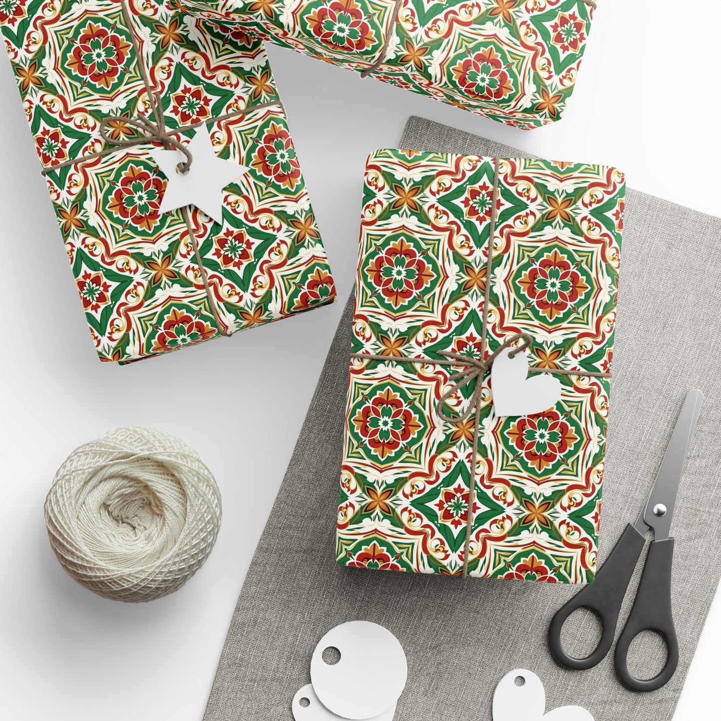 Gift wrap with green and red portuguese christmas pattern, scissors, and yarn on a white background
