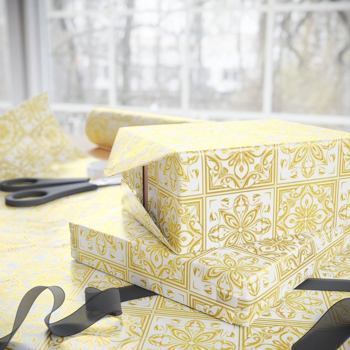 Gift box wrapped in gold and white tile patterned paper with scissors on a light background
