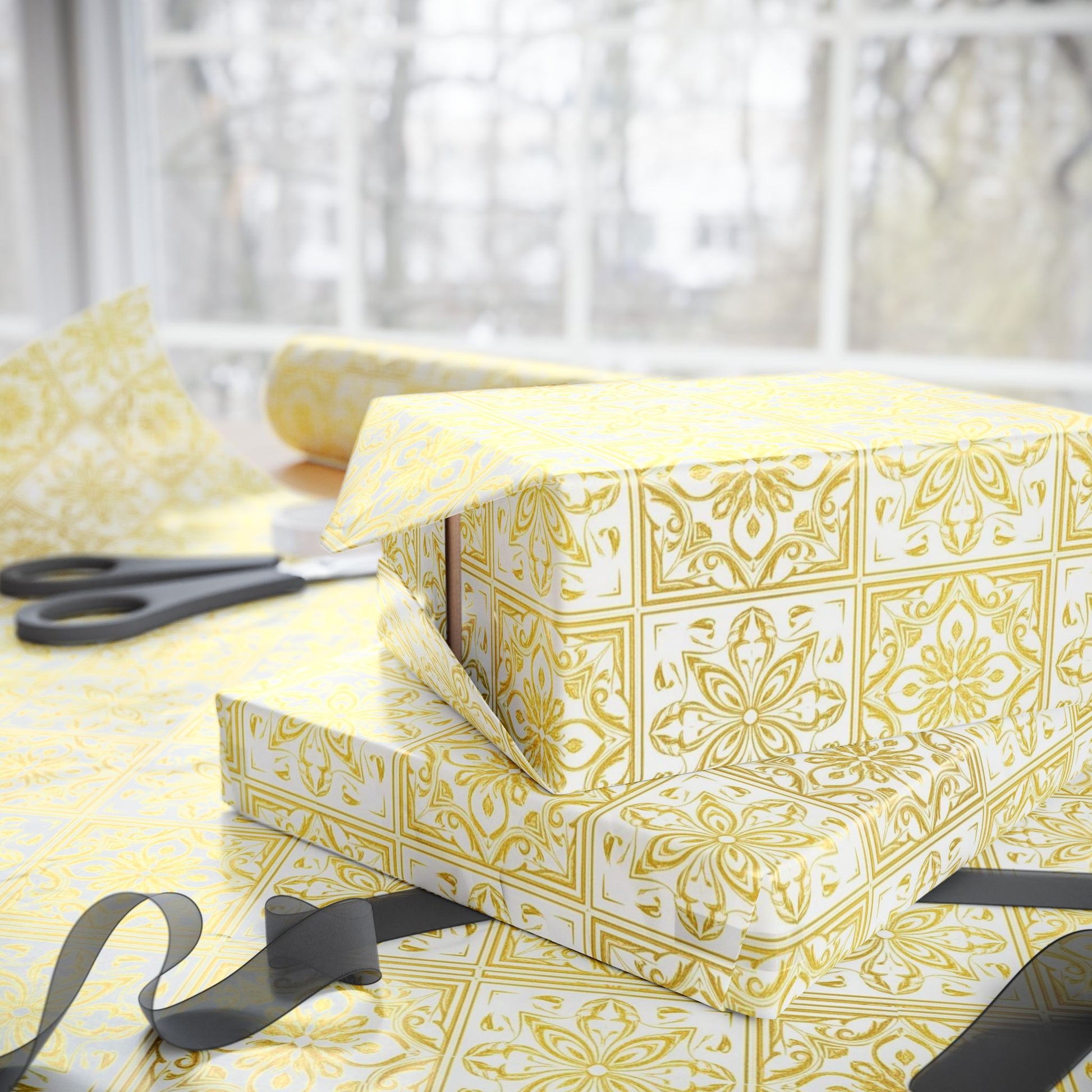 Gift box wrapped in gold and white tile patterned paper with scissors on a light background
