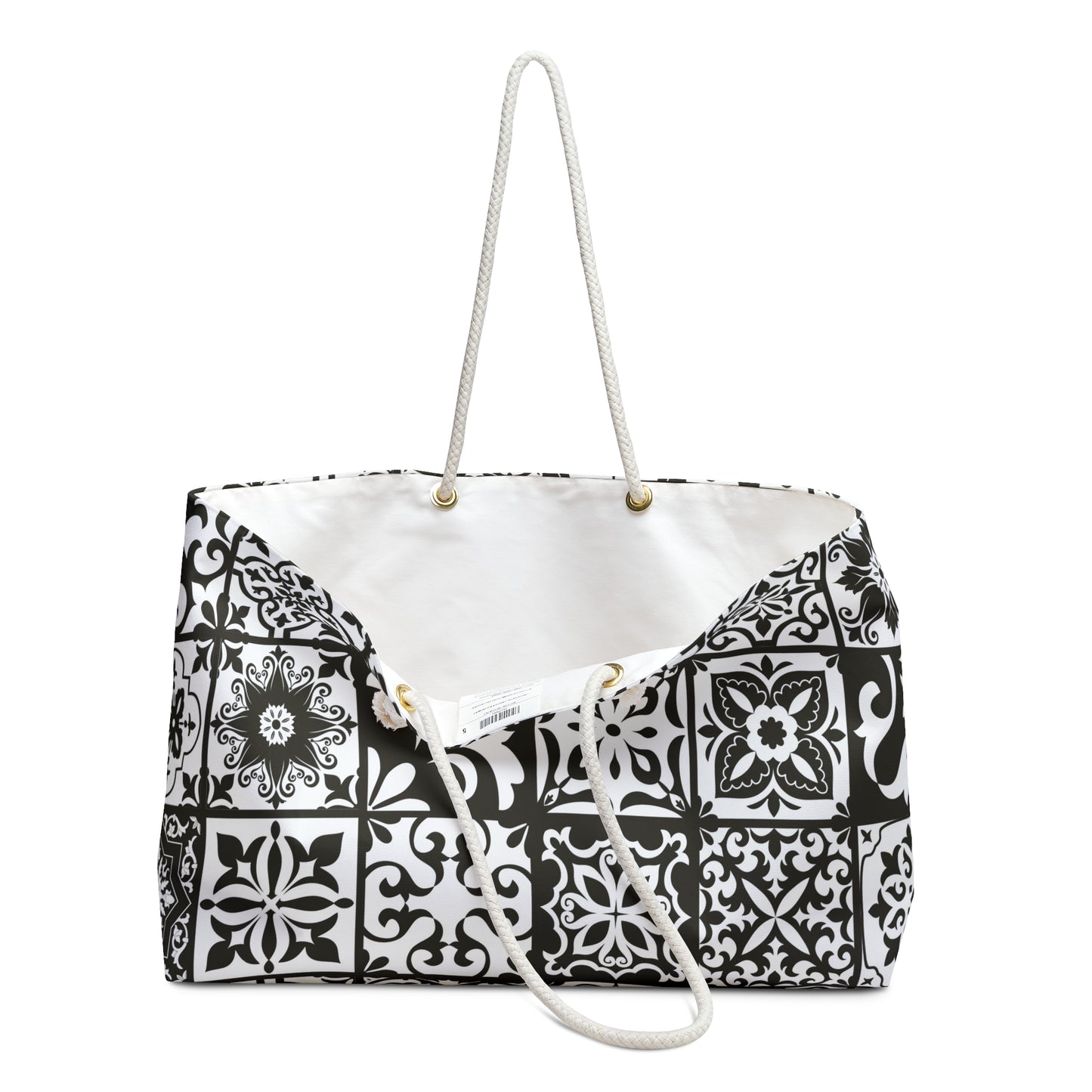 An oversized black and white Portuguese tile pattern tote bag with thick rope handles and a cream sheeting interior lining.