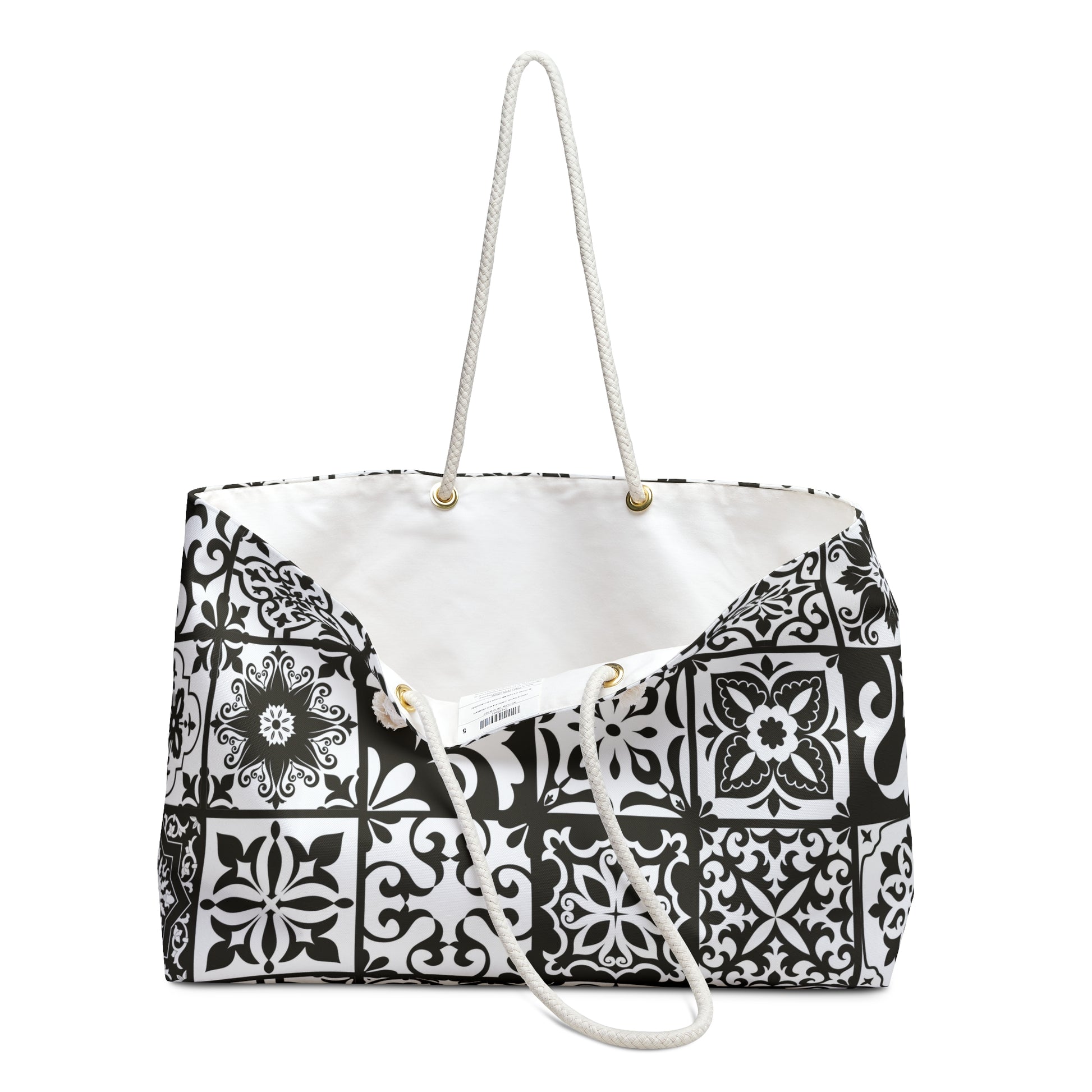 An oversized black and white Portuguese tile pattern tote bag with thick rope handles and a cream sheeting interior lining.