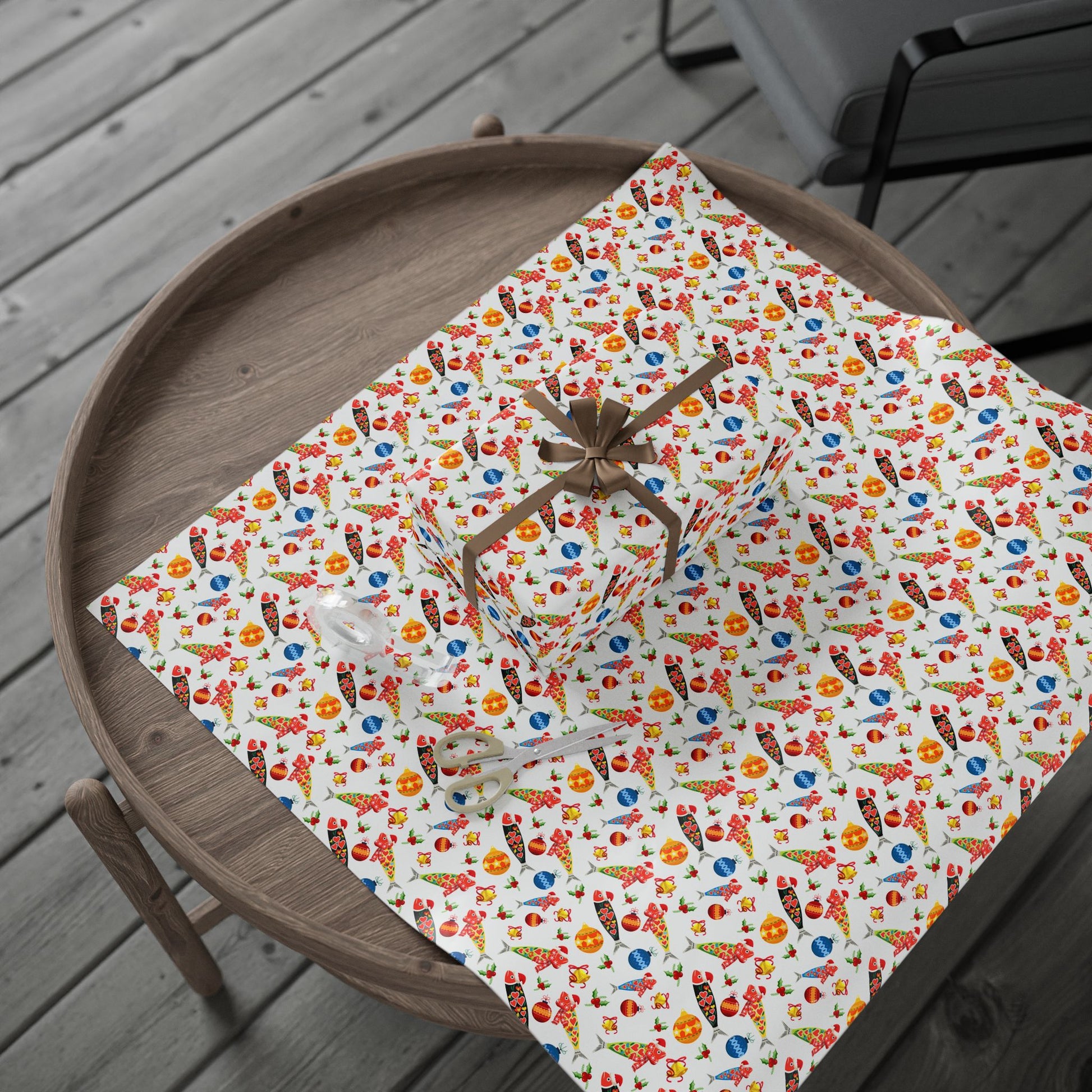 Colorful christmas sardine patterned wrapping paper on a wooden tray outdoors