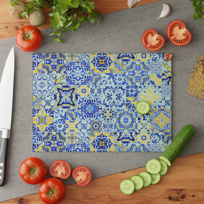 Colorful patterned cutting board on a gray surface with a knife and plant in the background.