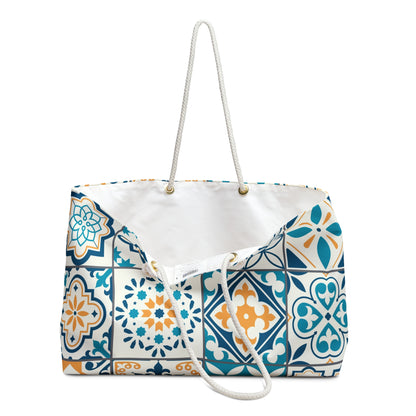 Oversized tote bag with a vibrant green, blue, and yellow Portuguese tile print, featuring thick rope handles and a cream sheeting interior lining.