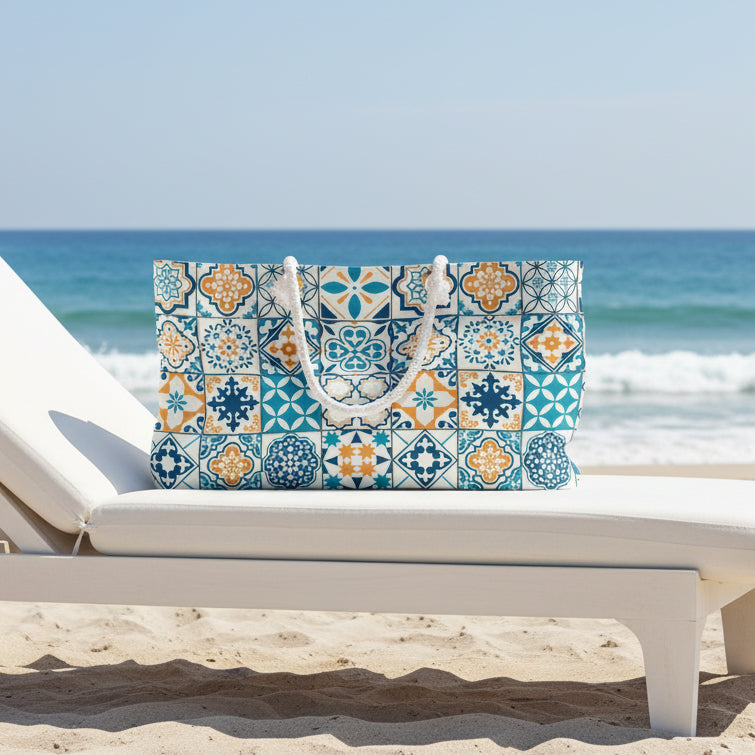 A tote bag featuring a colorful Mediterranean-style tile pattern in blue, teal, orange, and white, with two white rope handles, shown against a plain white background.