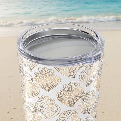 Tumbler with gold heart pattern on a white background