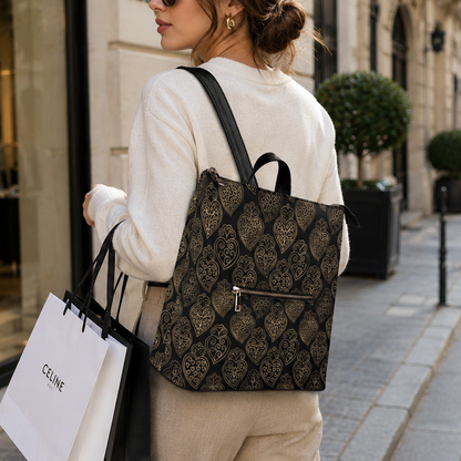 A woman on a city sidewalk wears a black and beige patterned Celine tote bag, holding a white Celine shopping bag.