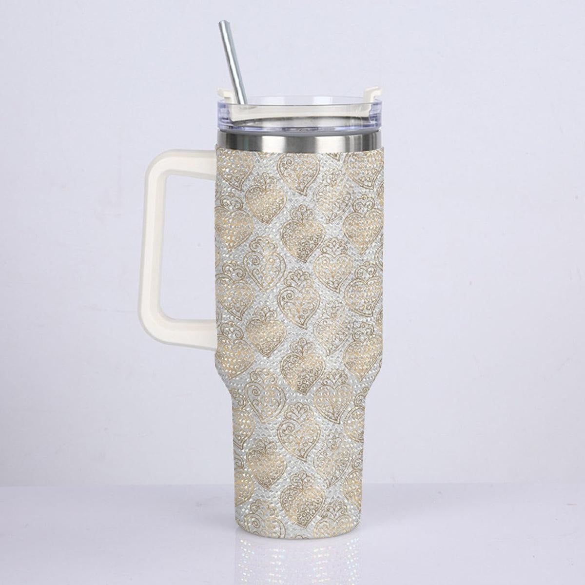 A tall handled travel tumbler with a snakeskin pattern in beige and white, featuring a clear lid with a silver metal straw, set against a plain light gray background.