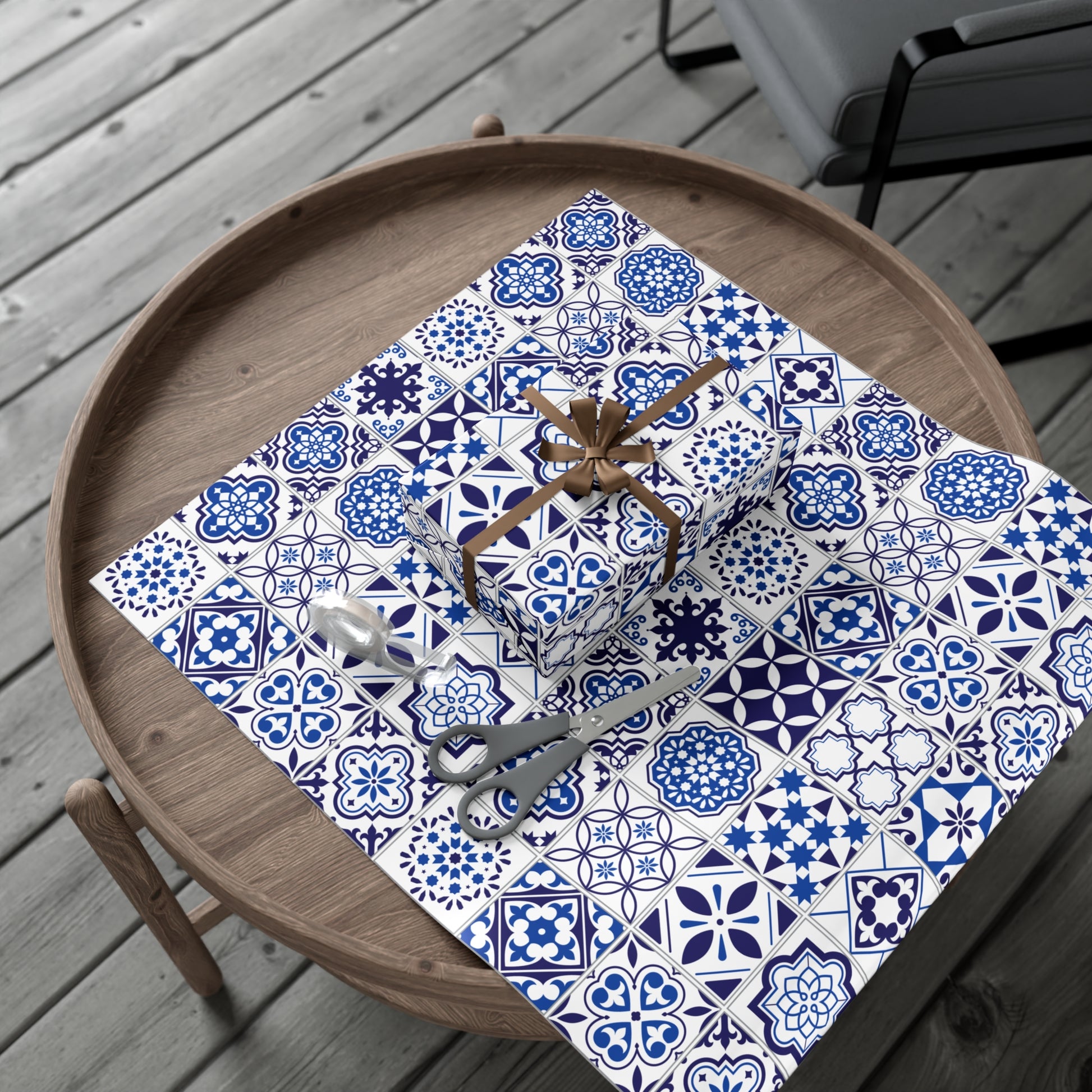blue and white tile patterned paper with decorative items on a wooden surface.
