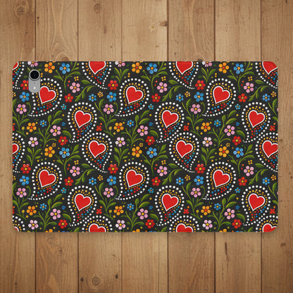 A protective tablet case featuring a dense folk-art style pattern of red hearts, green leaves, and colorful flowers on a dark background.