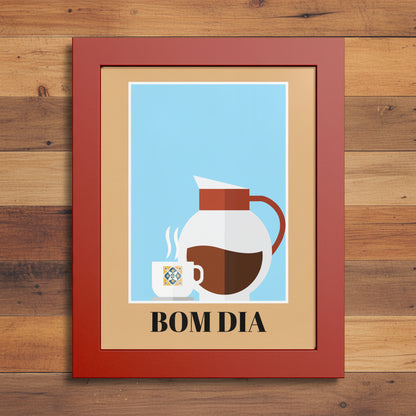 Framed wall art featuring a minimalist coffee-themed illustration with a white pitcher, a small cup, and the text 'BOM DIA' on a beige background, set in a red frame against a white backdrop.