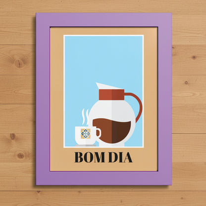 A framed art print with a lavender purple frame and a tan mat, featuring a minimalist illustration of a white coffee mug and a white coffee carafe with brown coffee on a light blue background, with the text 'BOM DIA' printed below.