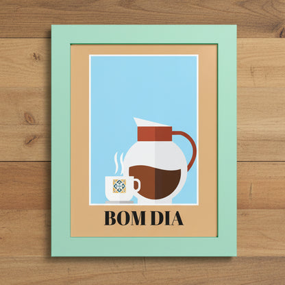 A framed art print with a mint green frame and tan mat, featuring a minimalist illustration of a white coffee pot, a small cup with steam, and the text 'BOM DIA' on a light blue background.